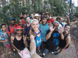A large group of people taking a selfie in the woods