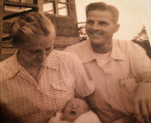 An old photograph of a man, woman, and their baby