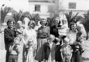 An old black and white photograph of five women and their children
