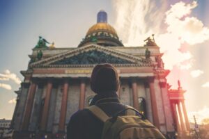 A person with a backpack looking at a building