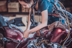 a woman working on a motorcycle