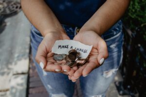 an open pair of hands holding change with a note that says "make a change"