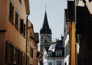 view of a clock tower between buildings