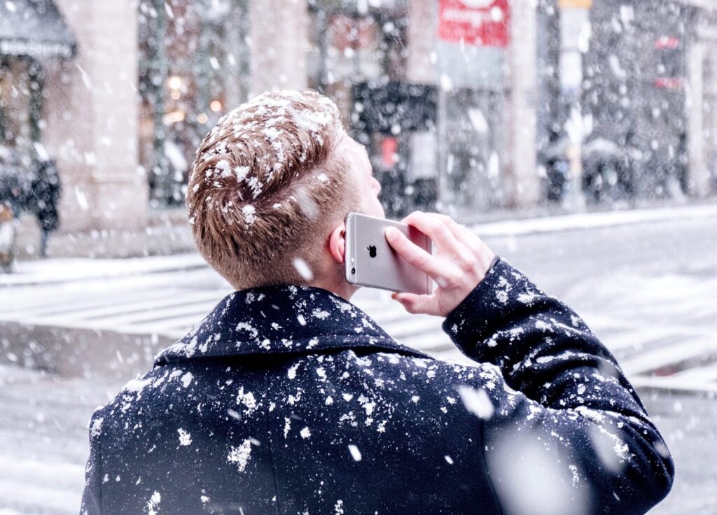 A person on the phone in the snow