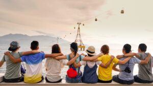 Eight people with their arms around each other's shoulders looking away from the camera