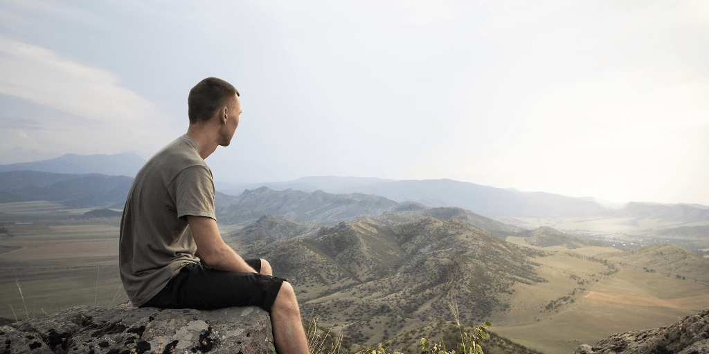 A man sitting on a mountaintop