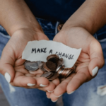 an open pair of hands holding change with a note that says "make a change"