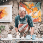 A man at a table painting crafts