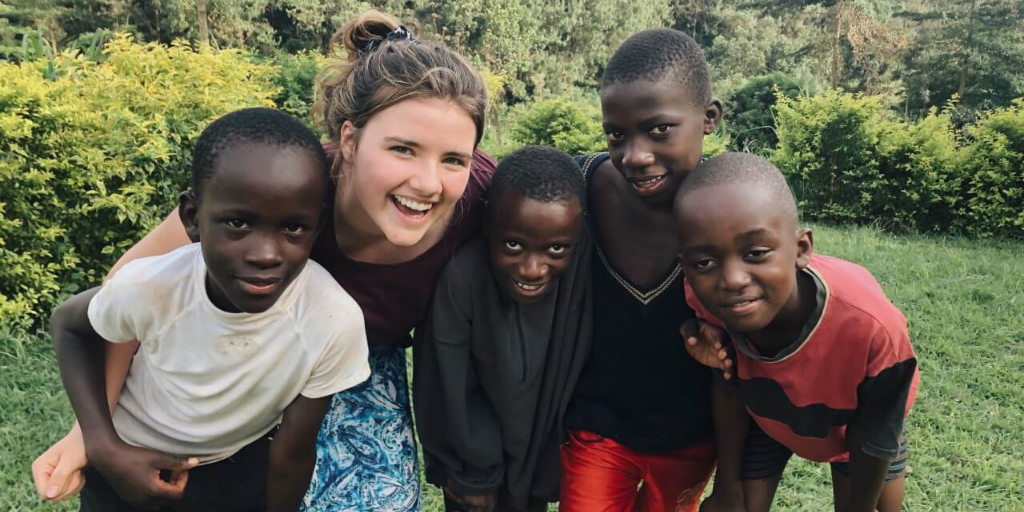 A woman posing with four children