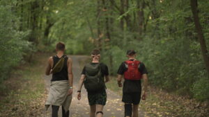 Three men walking down a path