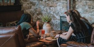 three women talking at a coffee table