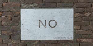 the word "NO" written on a wall
