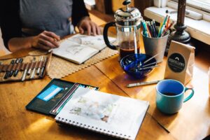 a person drawing at a desk